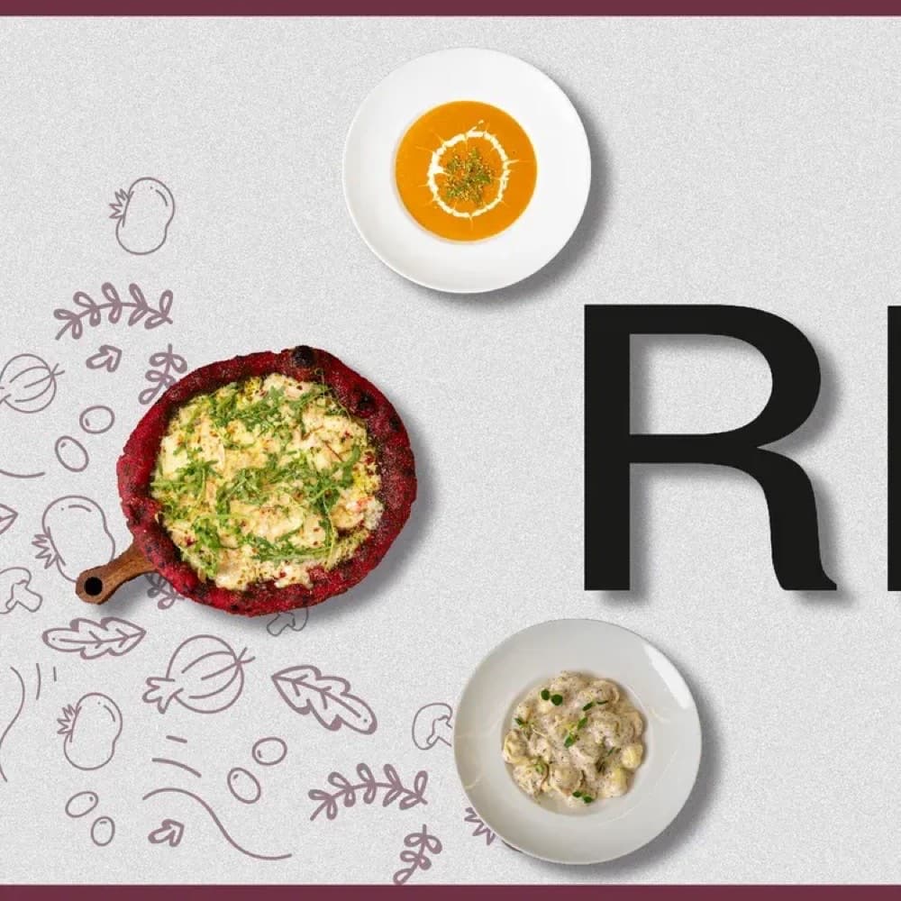 An overhead food shot of a wood-fired pizza and two plated sides arranged around a large letter R, from Regina's alphabet menu series