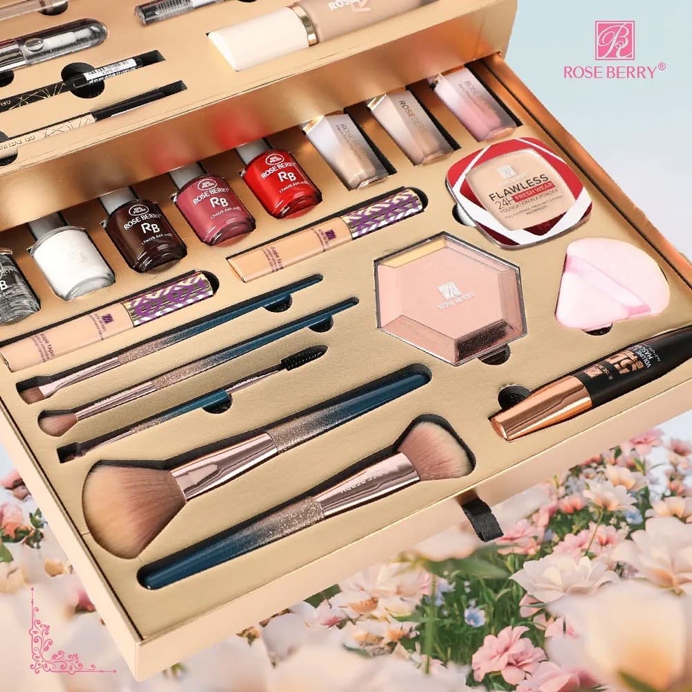 An open Rose Berry makeup kit with brushes and palettes, styled with blossom